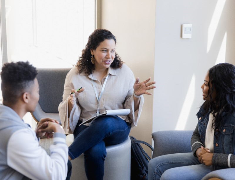 Photo of two teens meeting with counselor