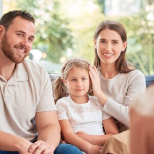 image of a young family having a discussion with someone at home
