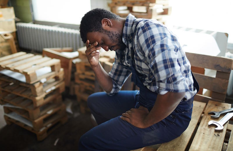 A man looking stressed sitting.